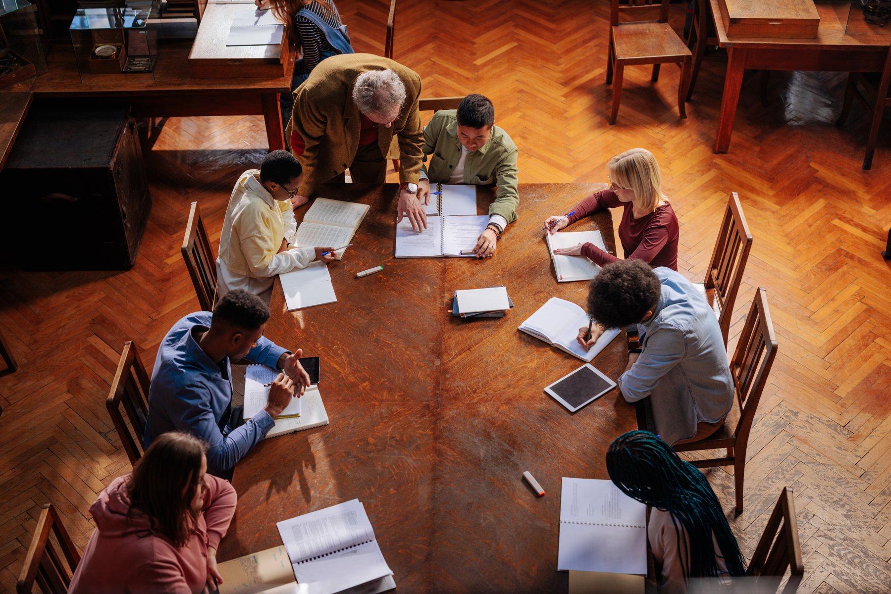 A small group of learners working together around a table.